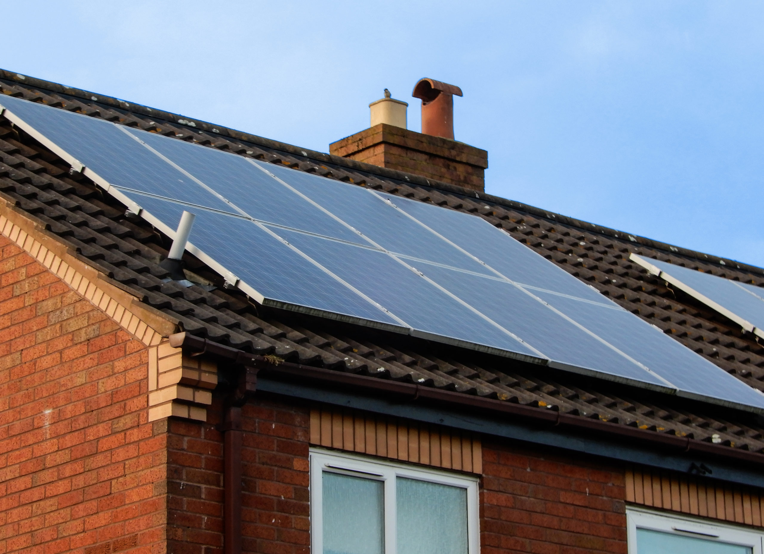 Solar panels mounted on a house roof as part of a retrofit
